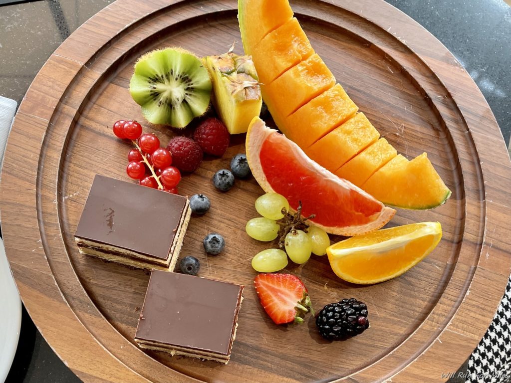 a plate of fruit on a wooden surface