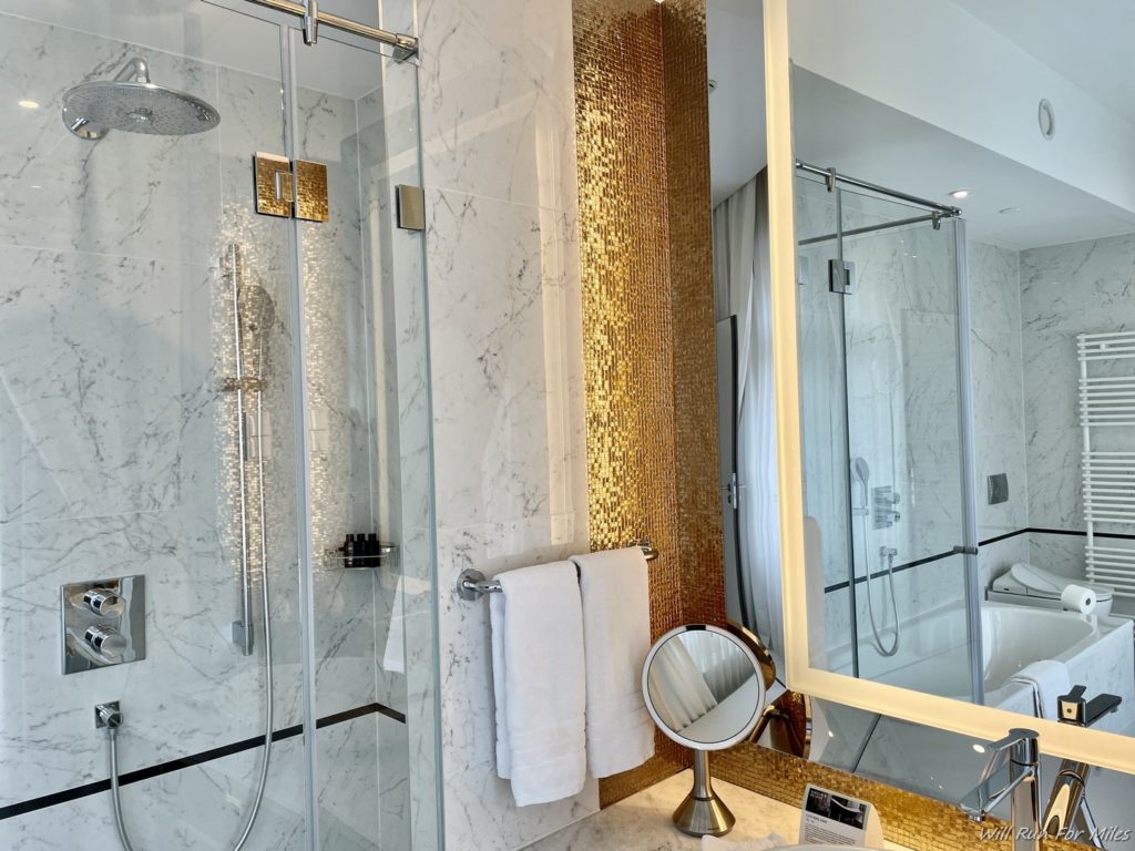 a bathroom with a mirror and a shower