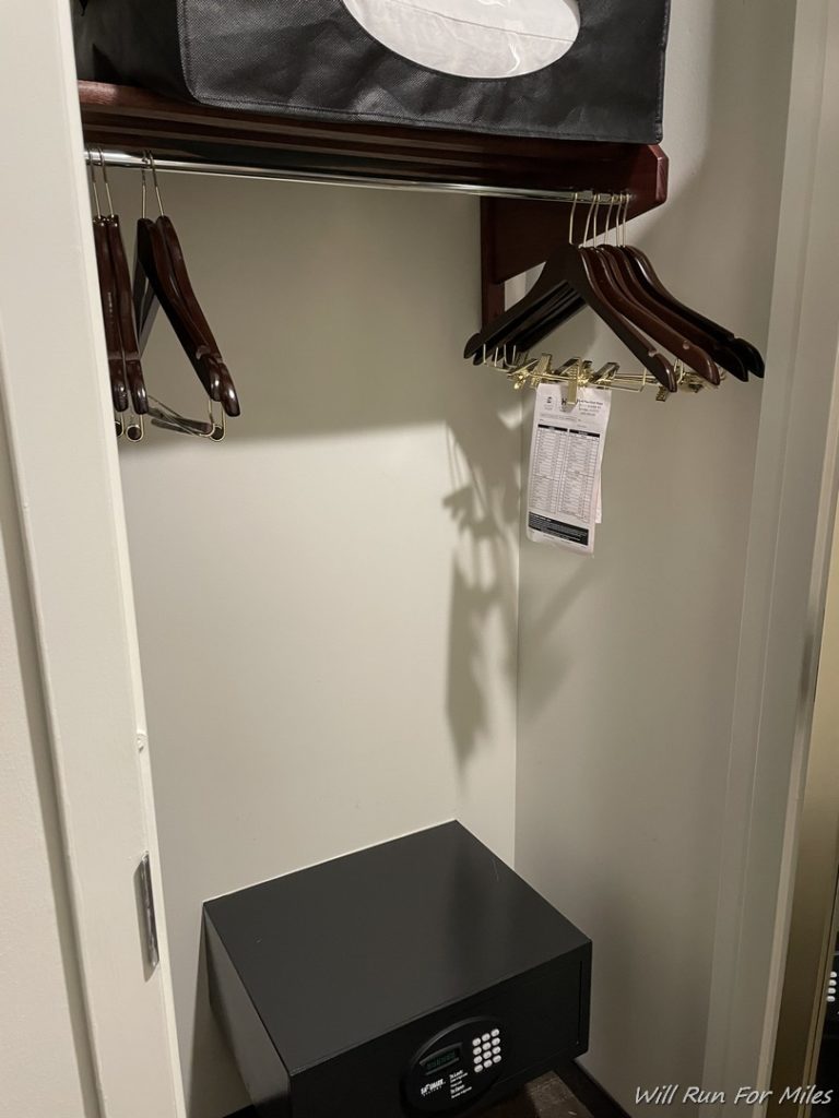 a closet with swingers and a small black box