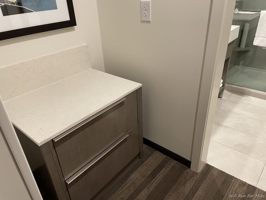 a white counter top next to a white wall
