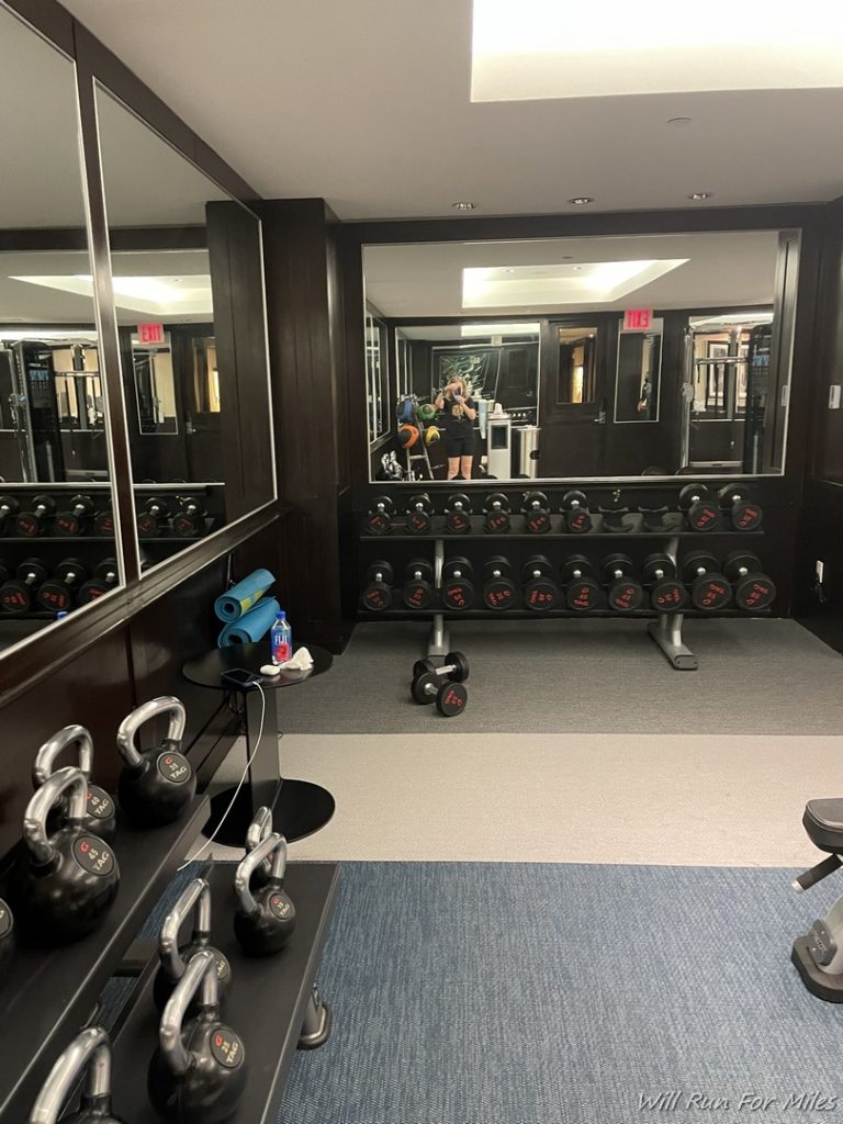 a mirror of a gym with weights and a mirror