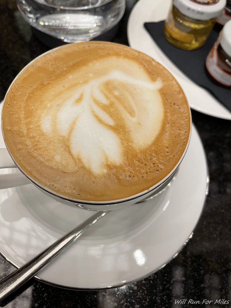 a cup of coffee with a design on the foam