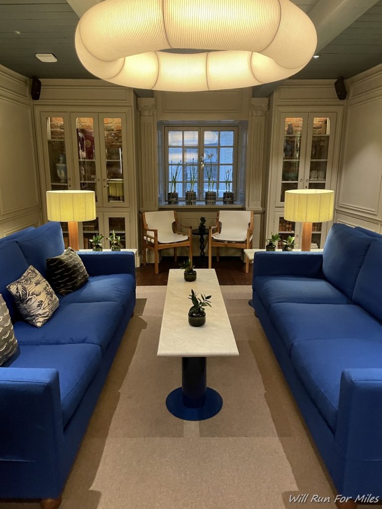 a living room with blue couches and a table