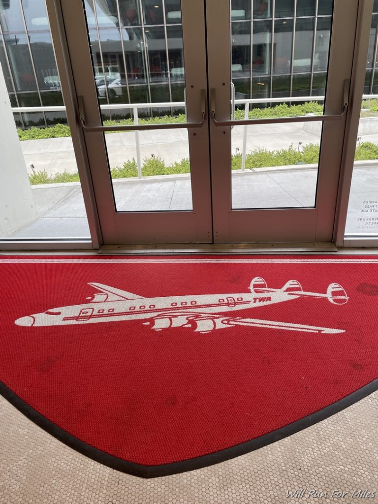a red rug with a picture of an airplane on it
