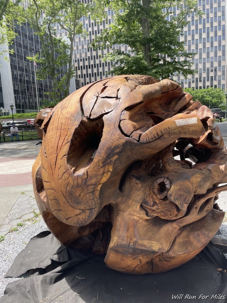 a large wooden sculpture in front of a building