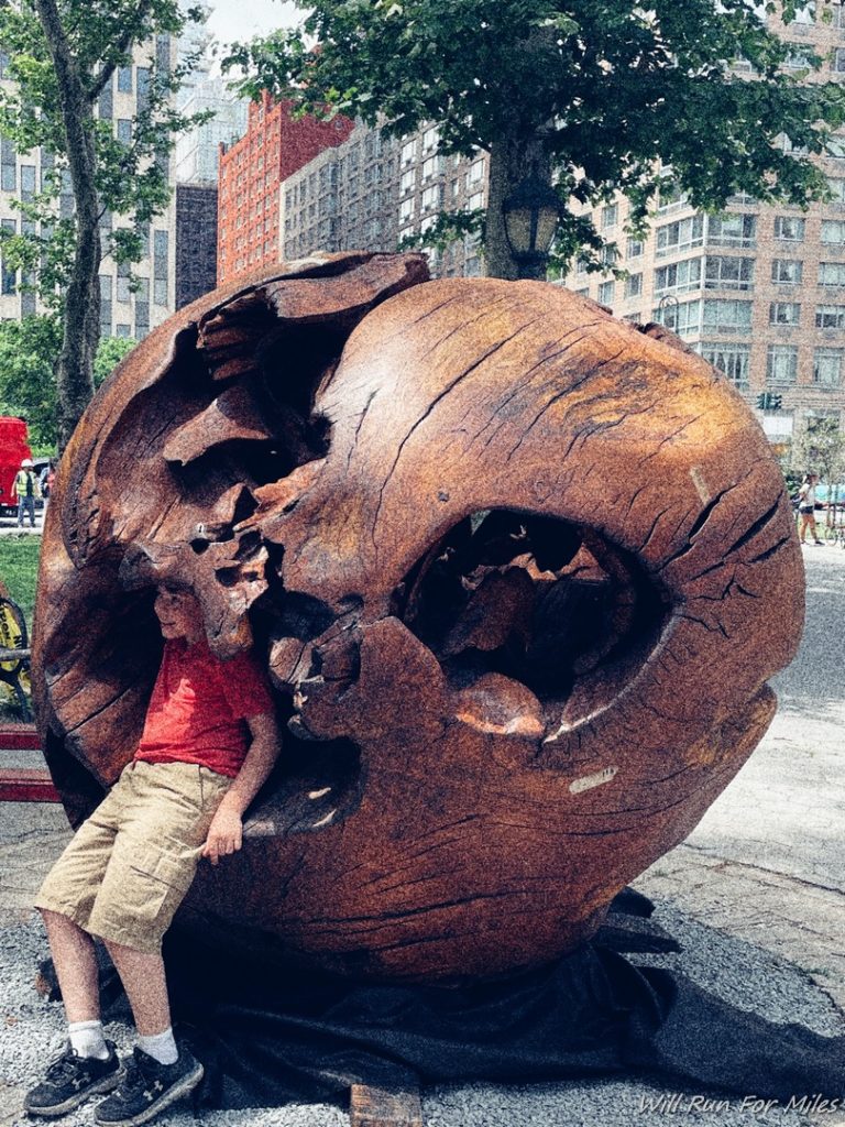 a man leaning on a large wooden object