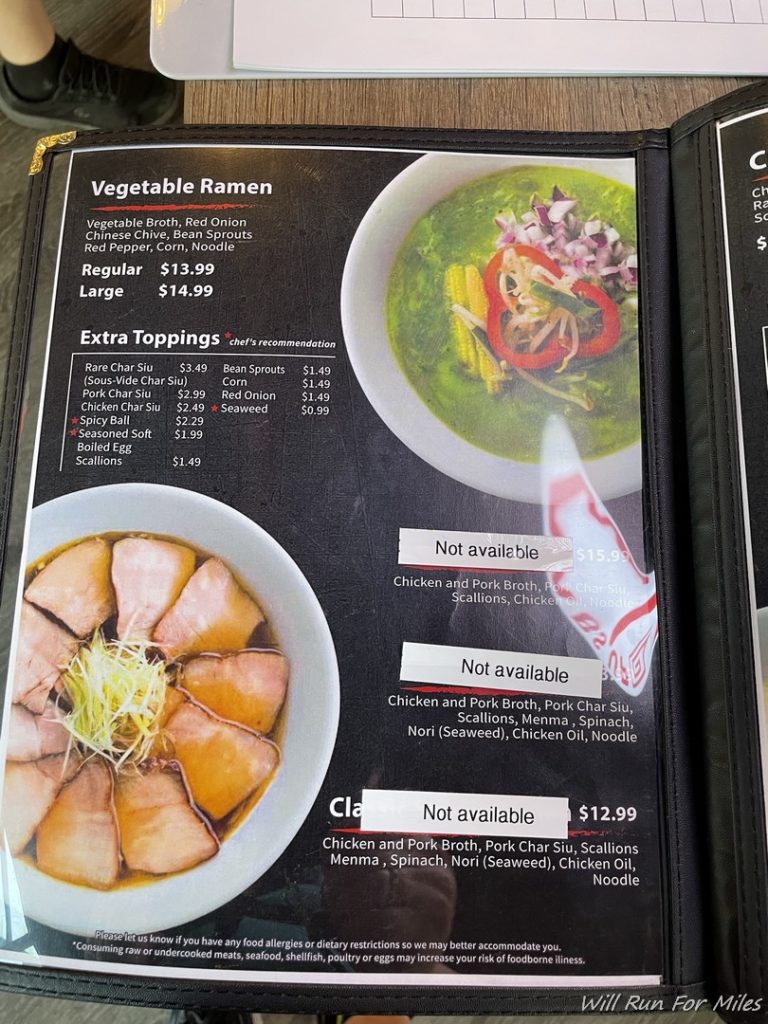 a menu with a picture of soup and vegetables