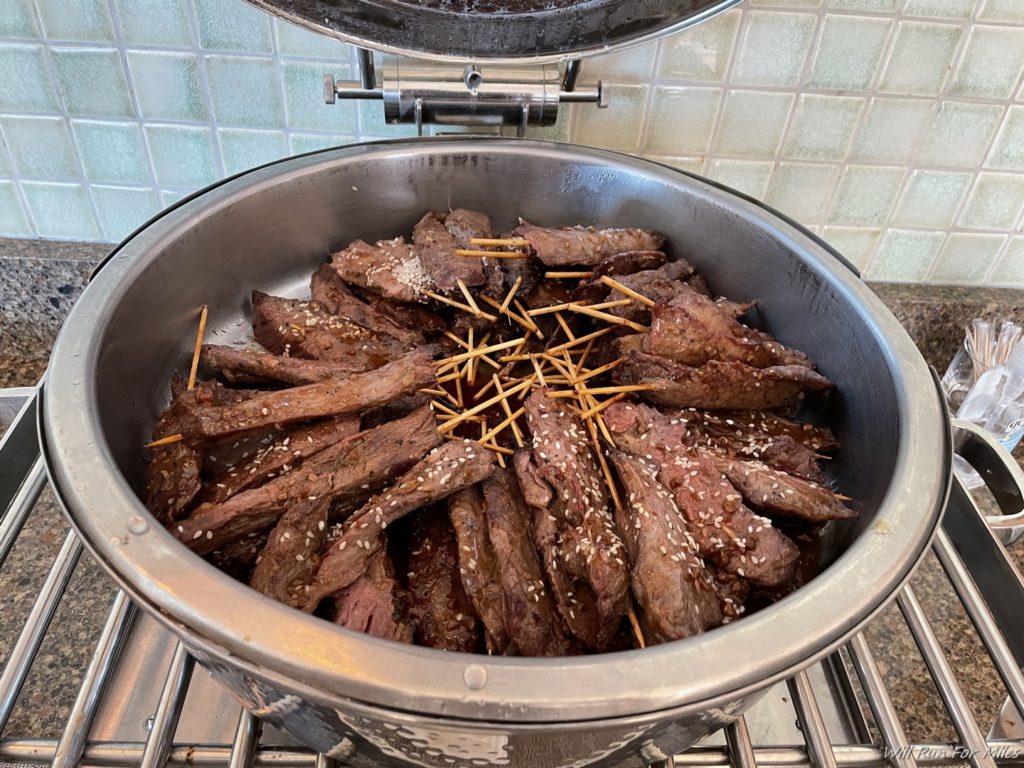 a bowl of meat and toothpicks