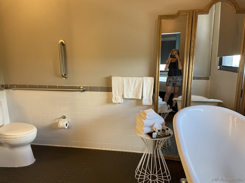 a woman taking a picture of herself in a bathroom