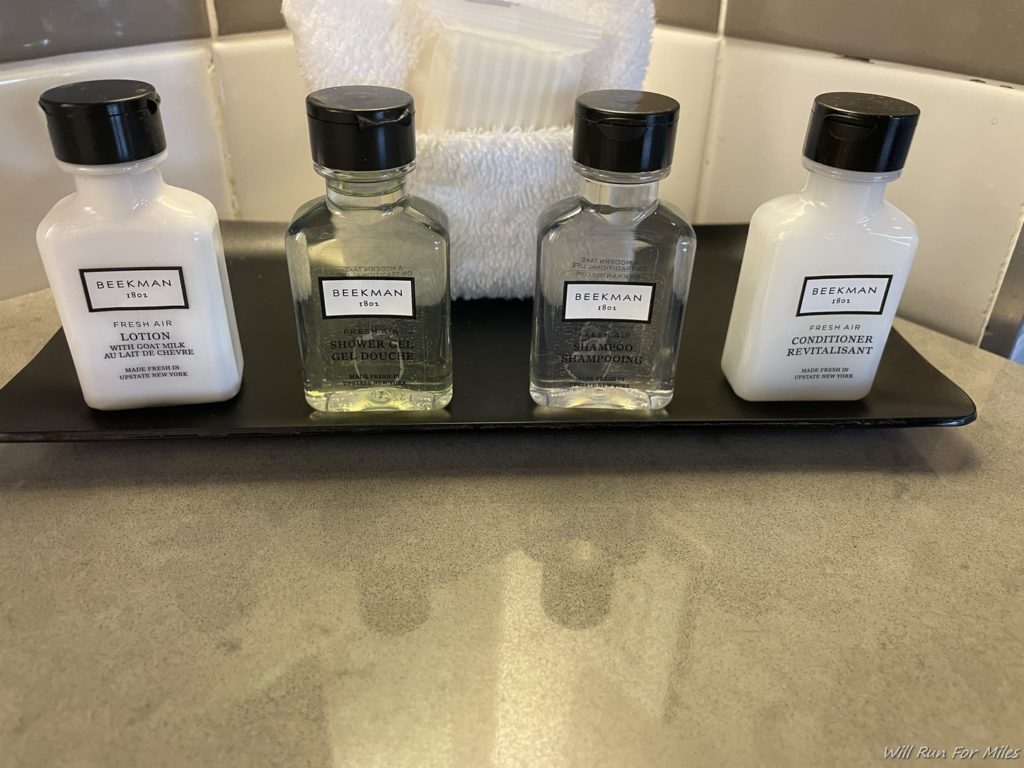 a group of small bottles on a black tray