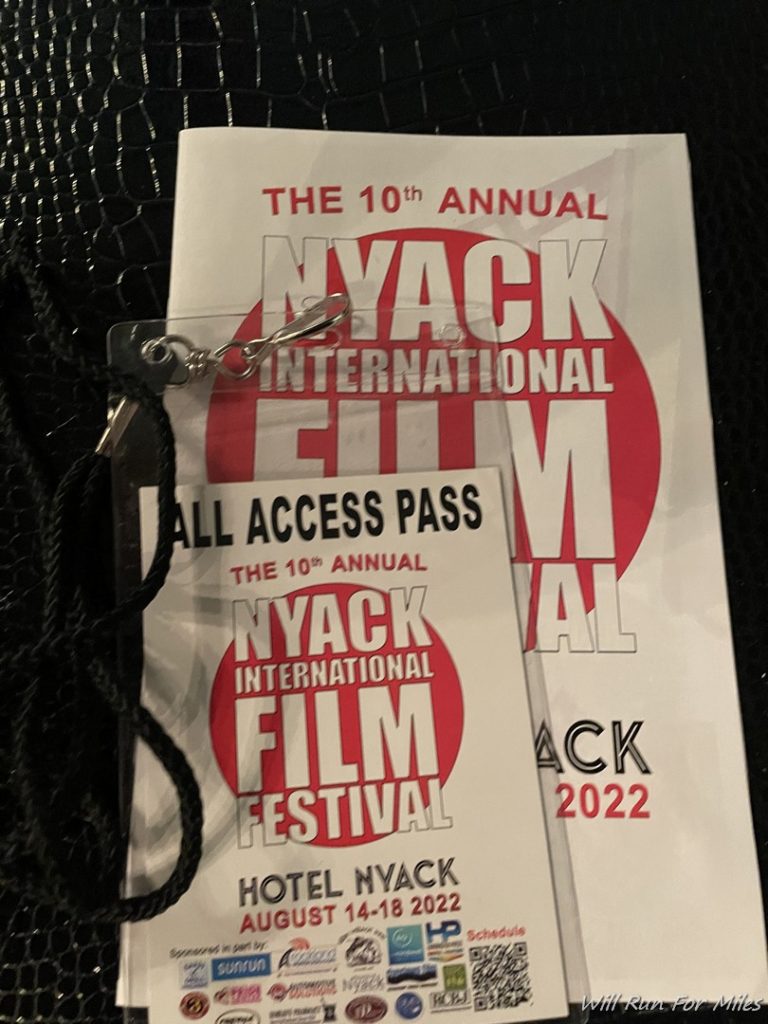a white and red tickets with a black string