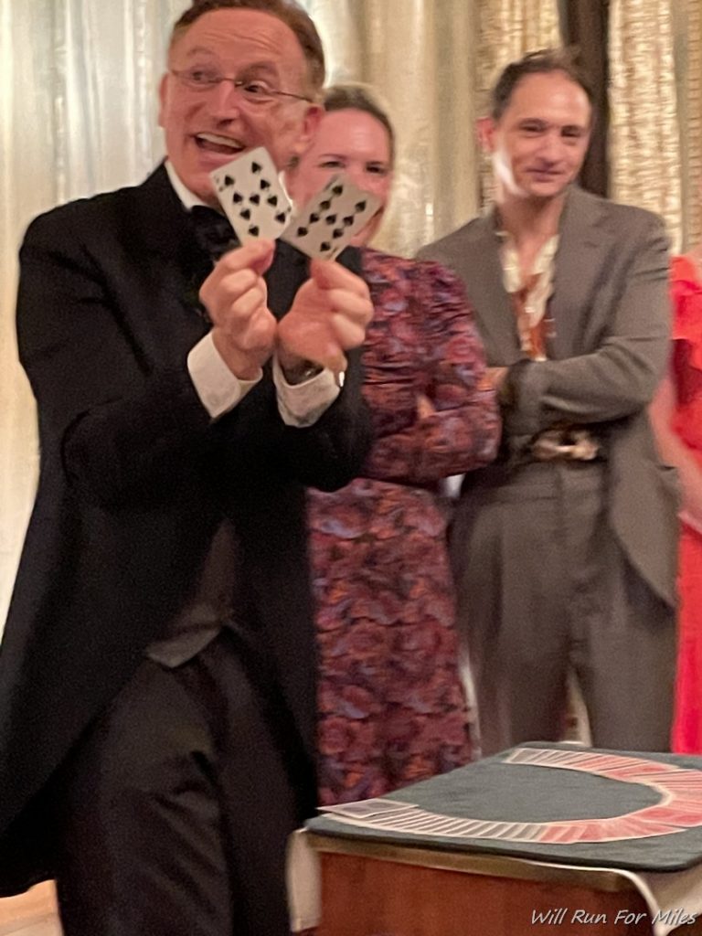 a man in a suit holding up cards