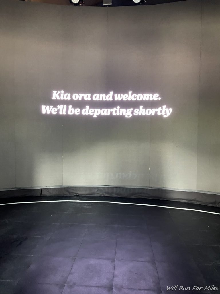 a room with a black floor and a white text on the wall
