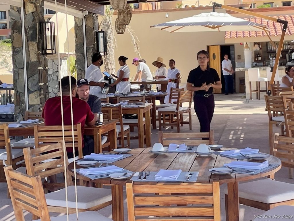 a group of people at tables outside