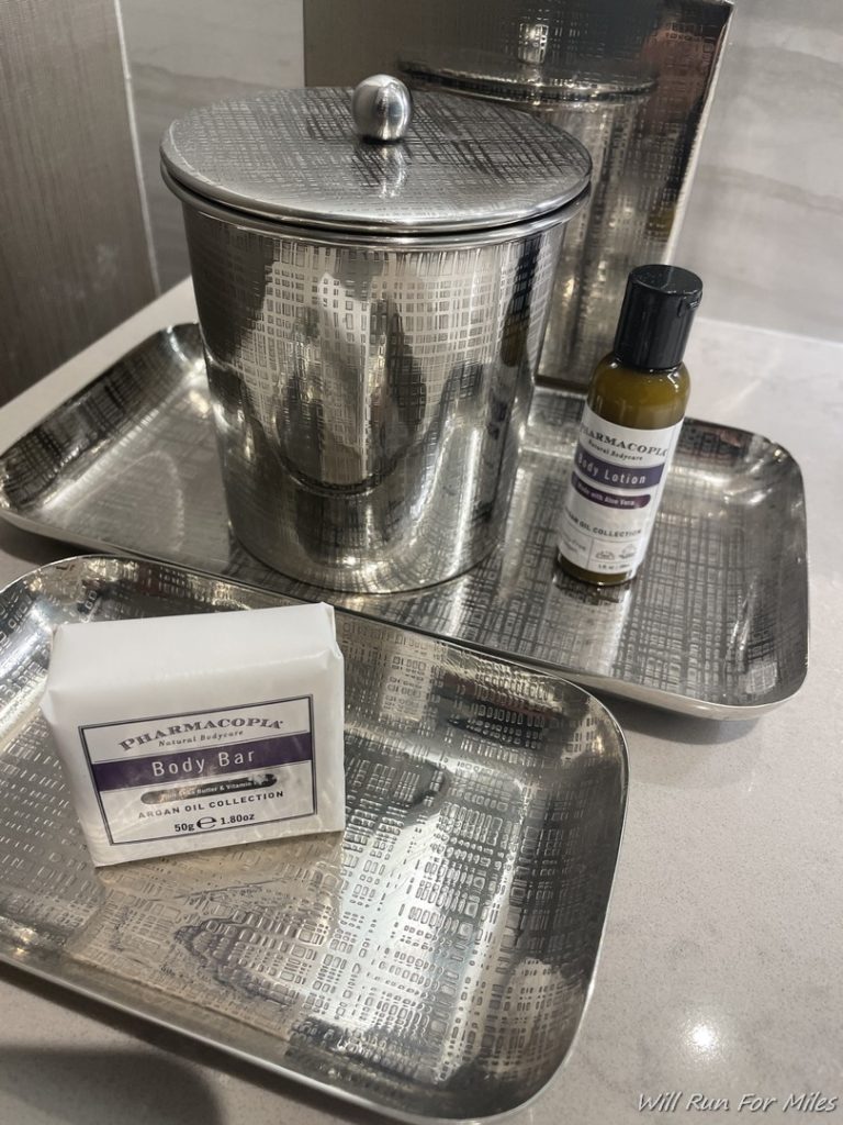 a silver trays with a container and a bottle of body bar