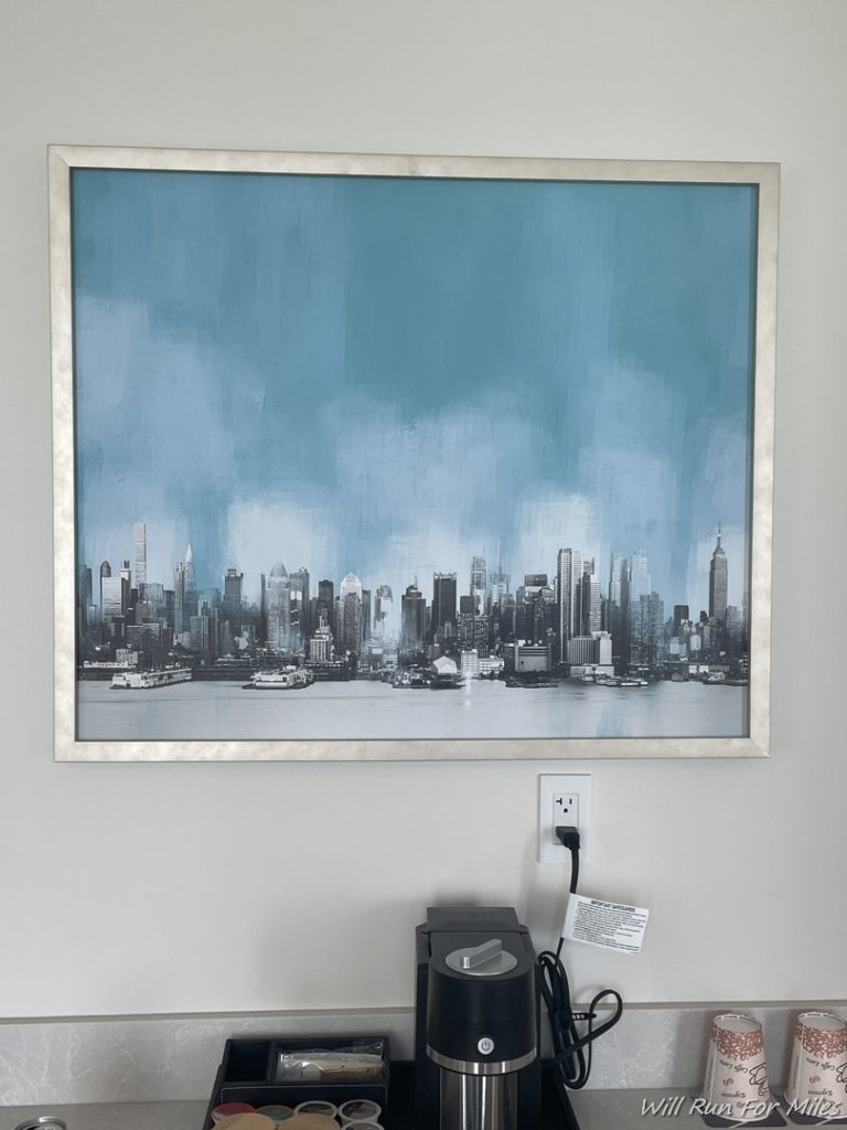 a picture of a city in a frame on a wall