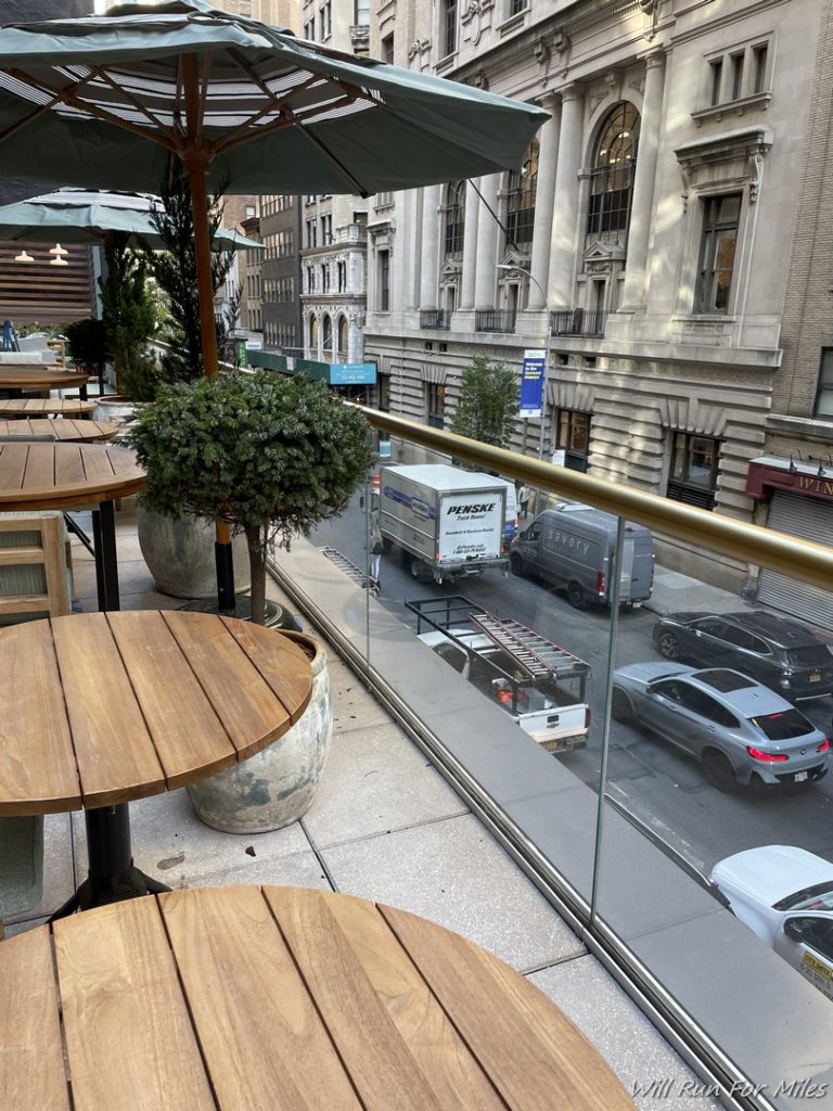 a view of a street from a balcony of a restaurant