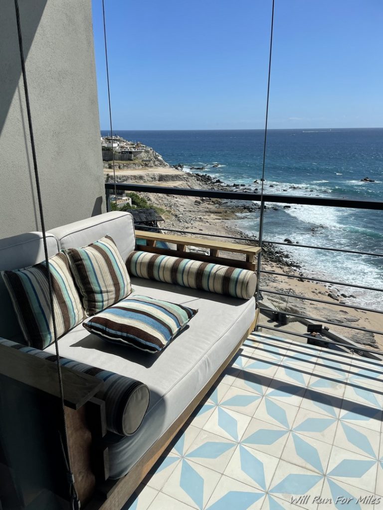 a couch on a balcony overlooking the ocean