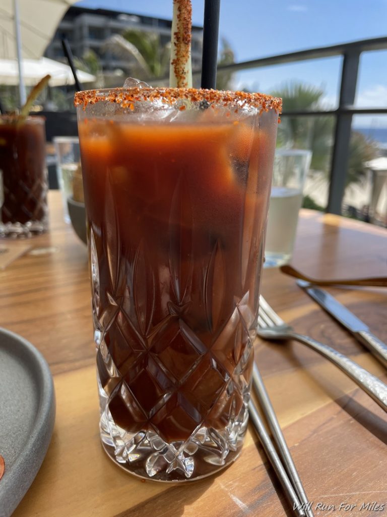 a glass of liquid with a straw