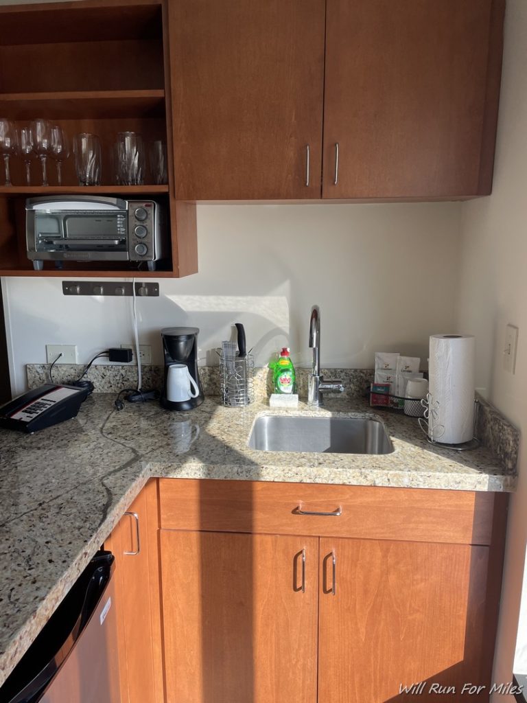 a kitchen counter with a sink and a microwave