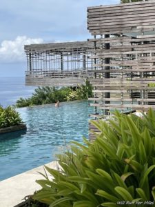 a pool with a building and a person swimming in it