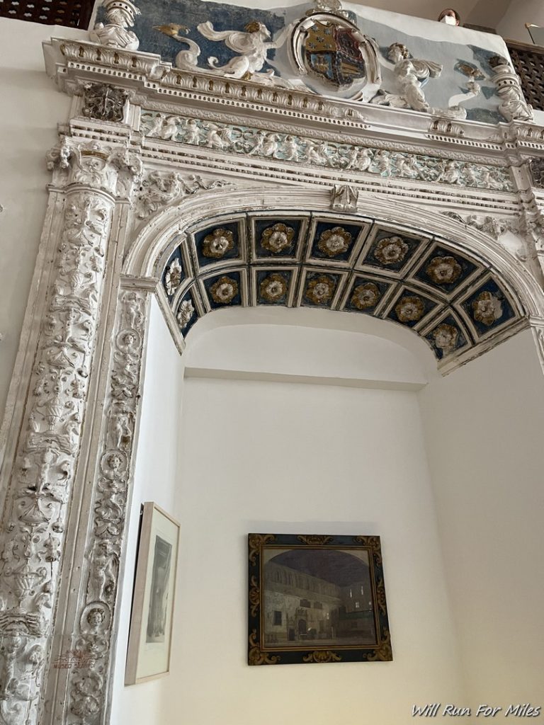 a ornate archway with artwork on the wall