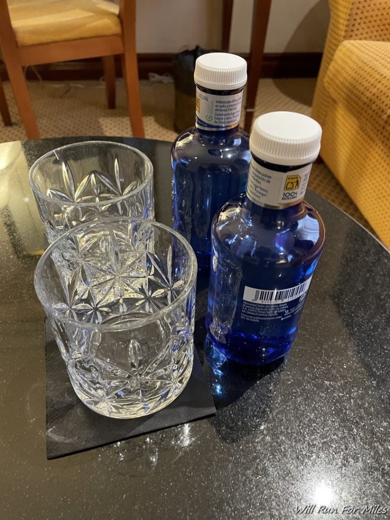 a group of blue bottles and glasses on a table