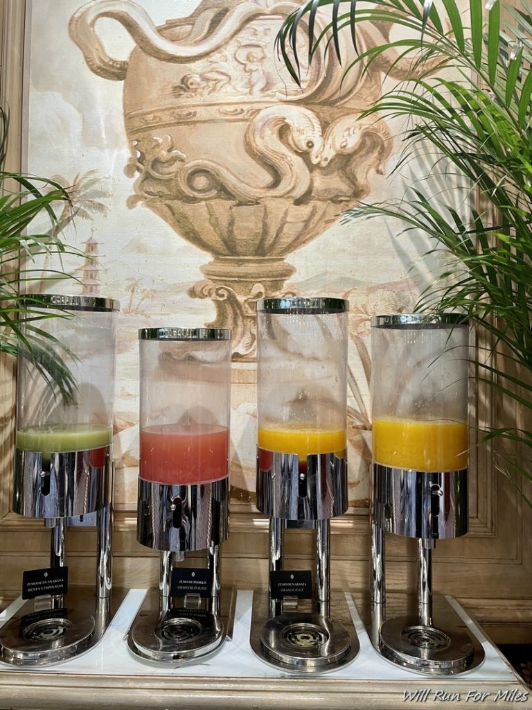 a group of juice dispensers in a room