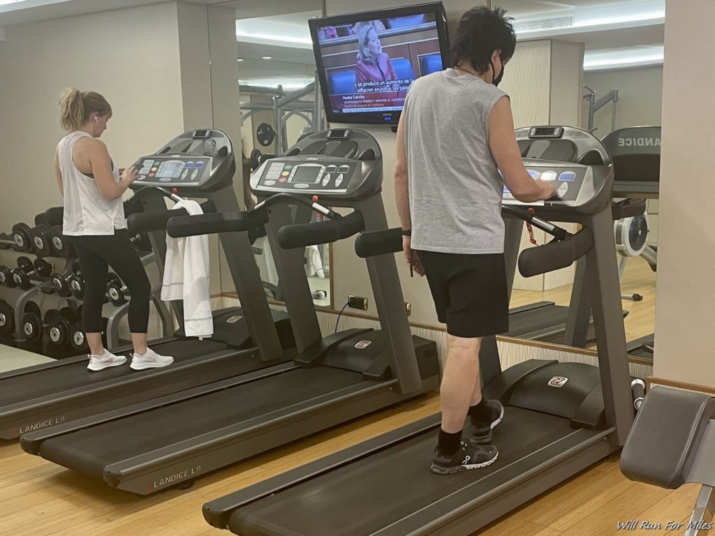 a man and woman on treadmills in a gym