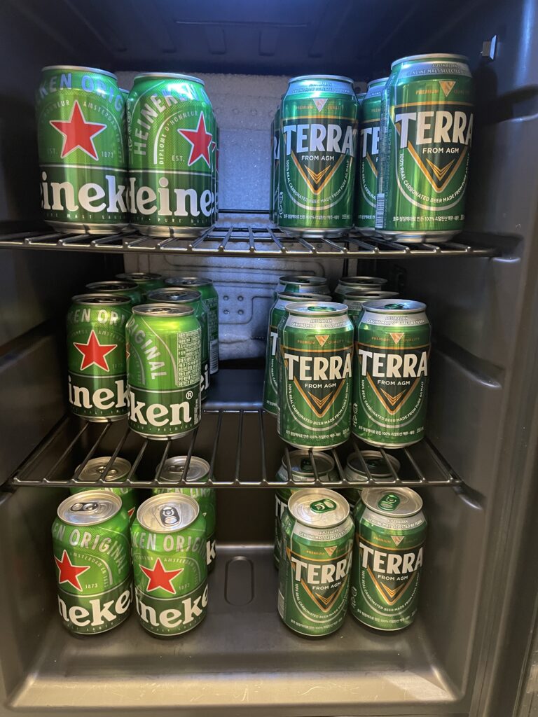 a shelf of green cans