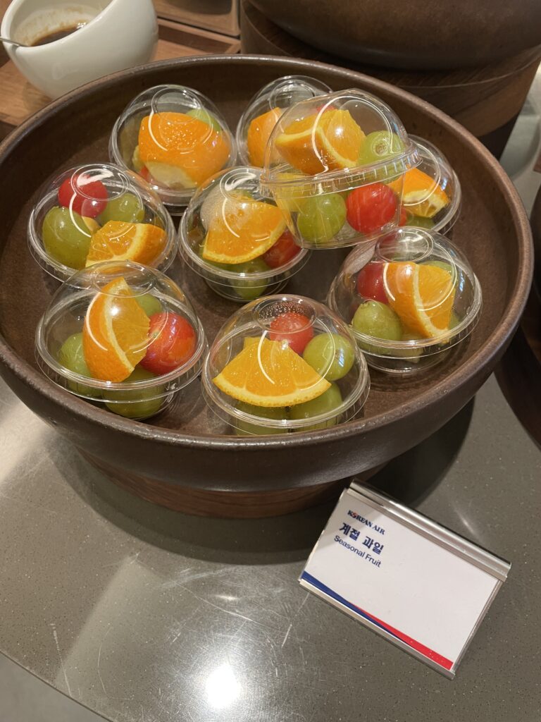 a bowl of fruit in plastic cups