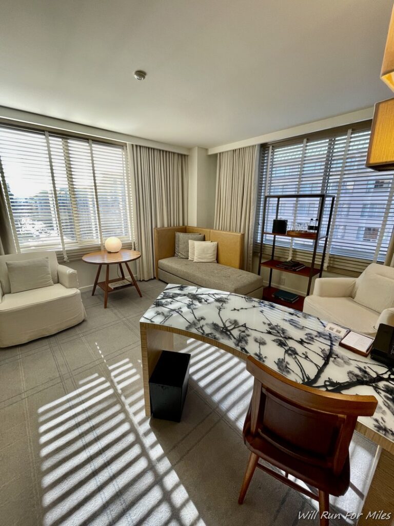 a room with a marble desk and couches