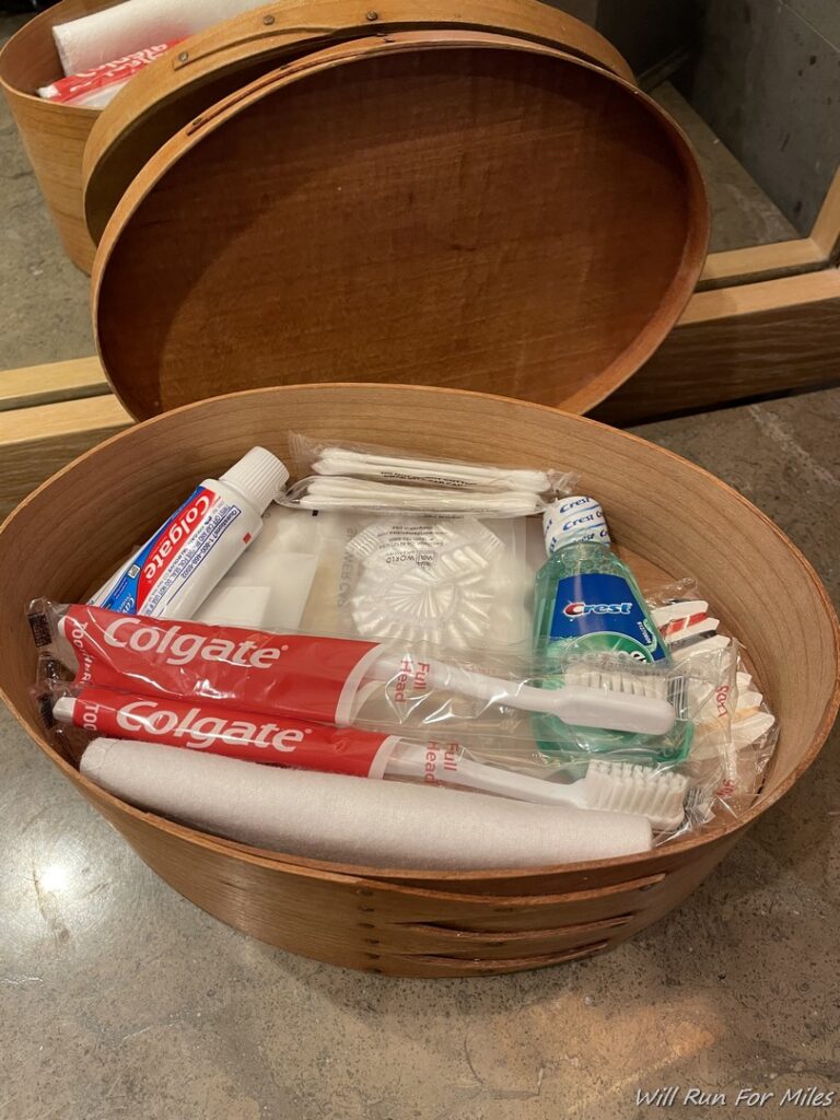 a basket with toothbrushes and toothpaste in it