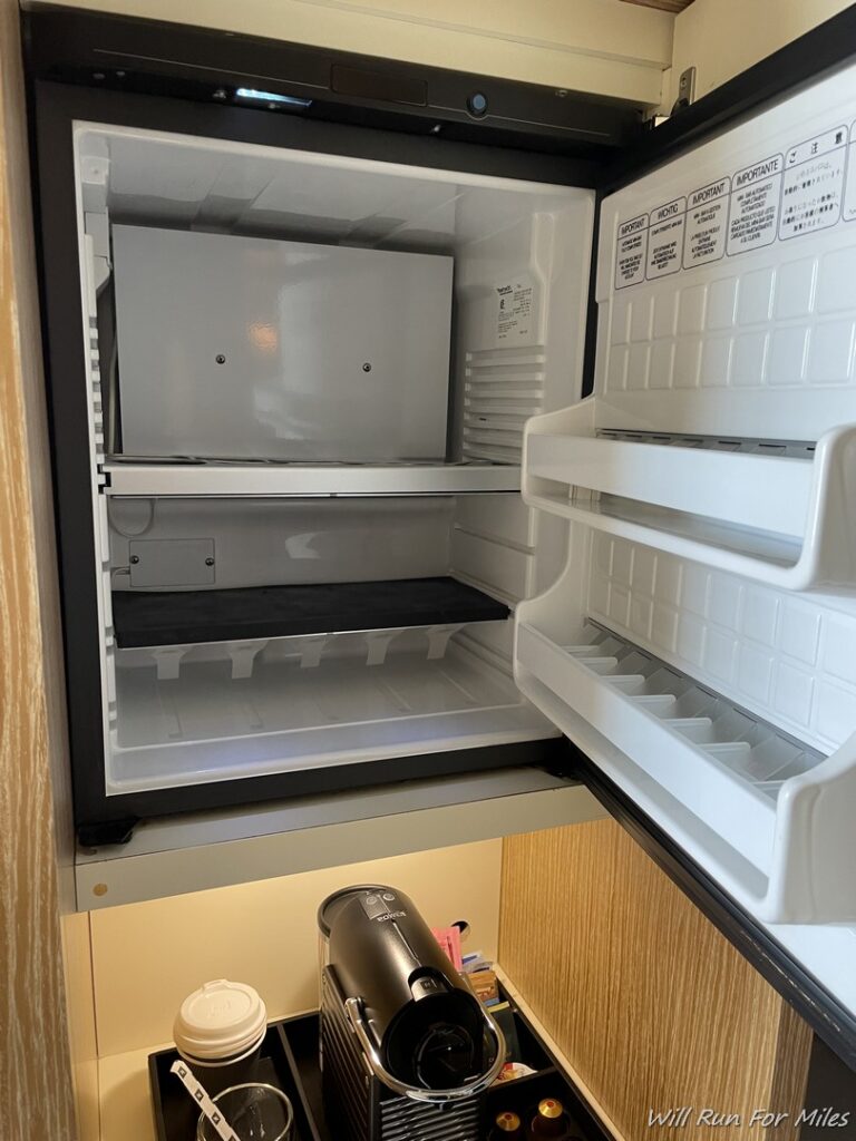 a refrigerator with shelves and a hair dryer