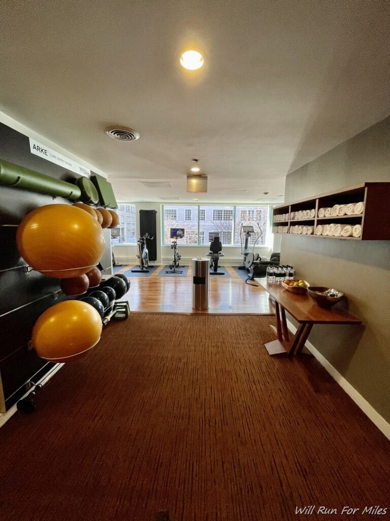 a room with exercise equipment and a blackboard