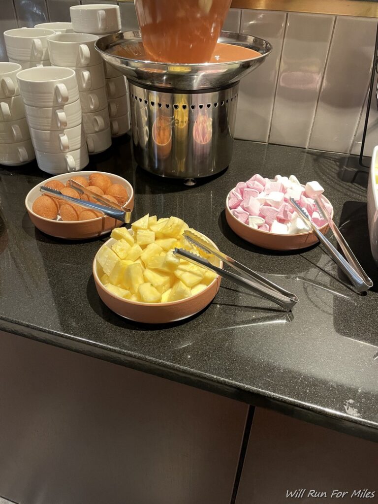 bowls of fruit and marshmallows on a counter