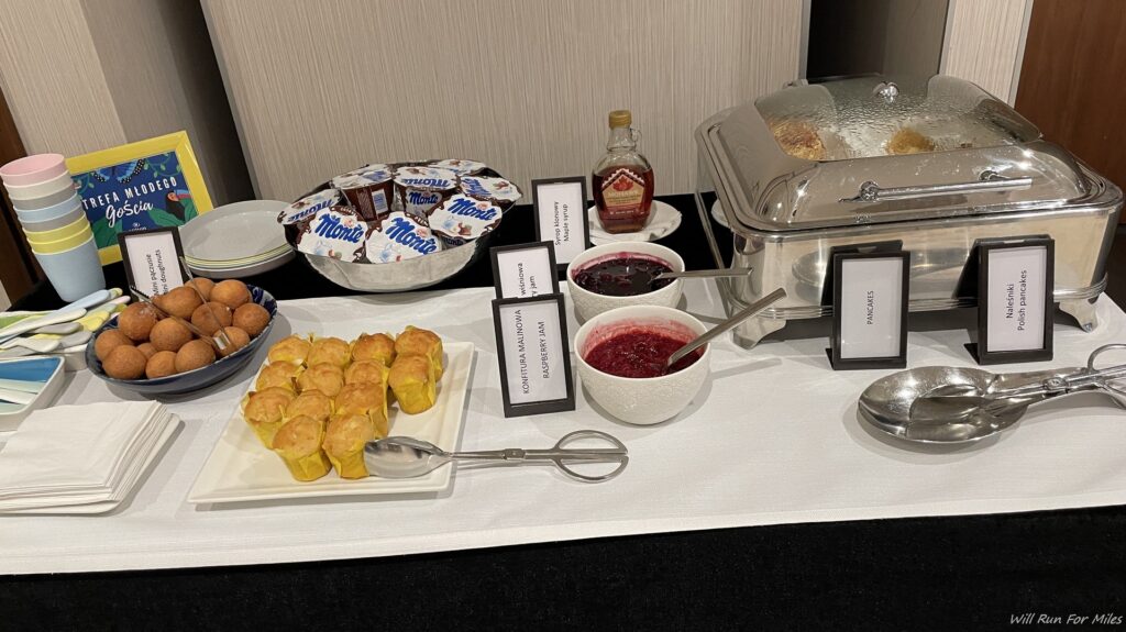 a buffet table with food and name cards