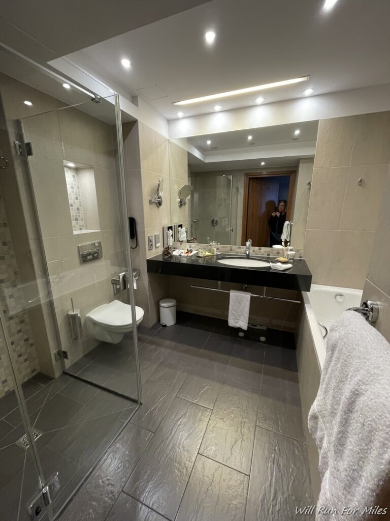 a bathroom with a mirror and a bathtub