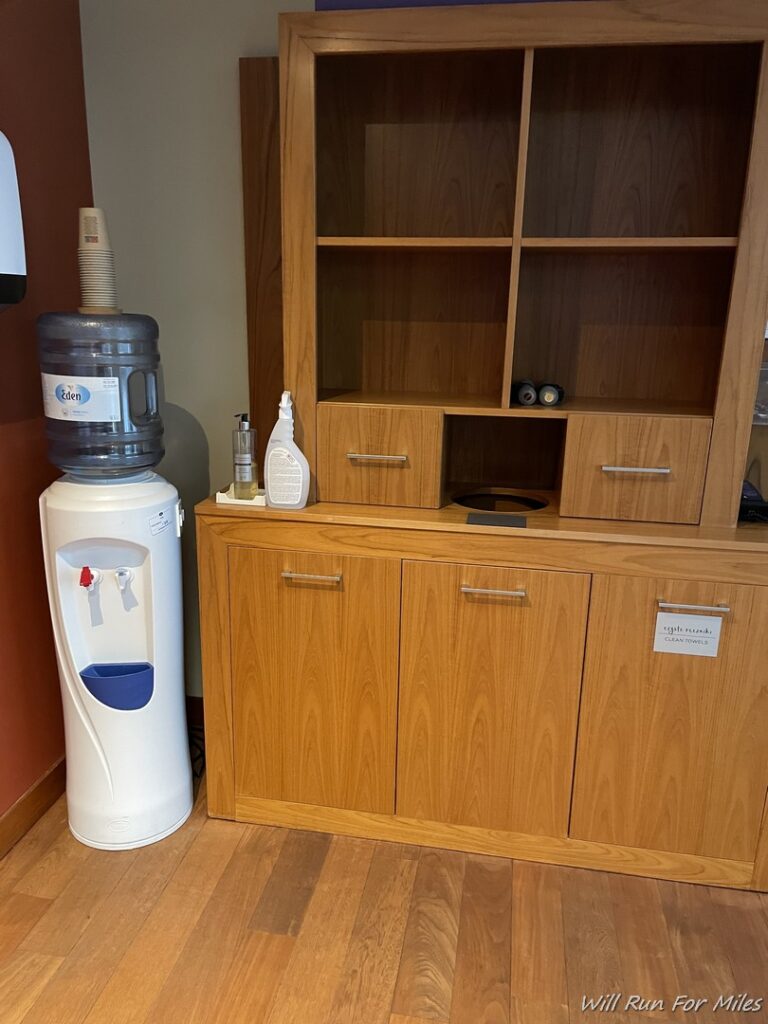 a water cooler and shelves in a room