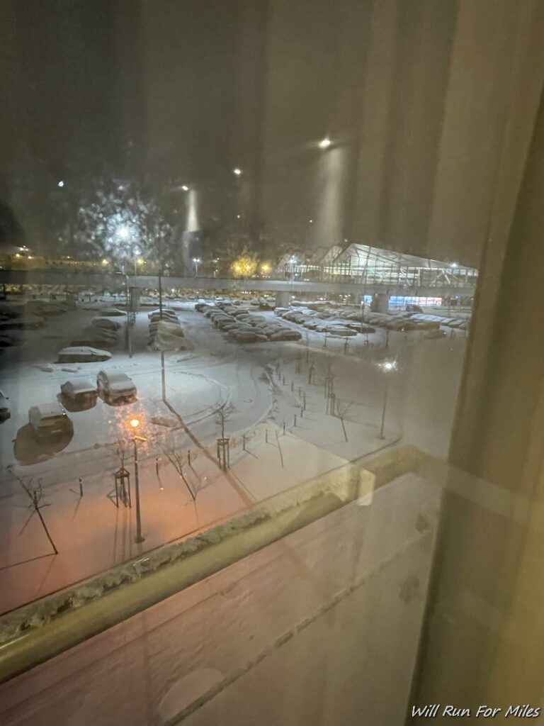 a view of a parking lot from a window at night