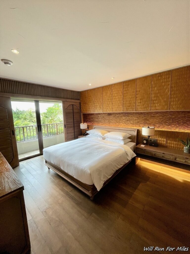 a bedroom with a bed and a wood floor