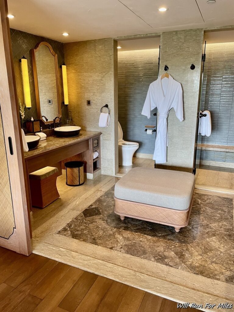 a bathroom with a white robe on a swinger