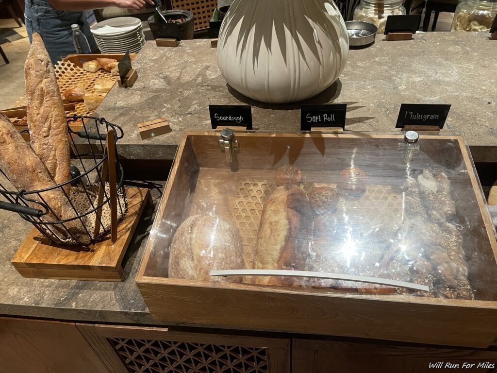 a counter with bread in a glass case