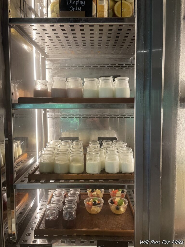 a shelf with jars of milk and fruit