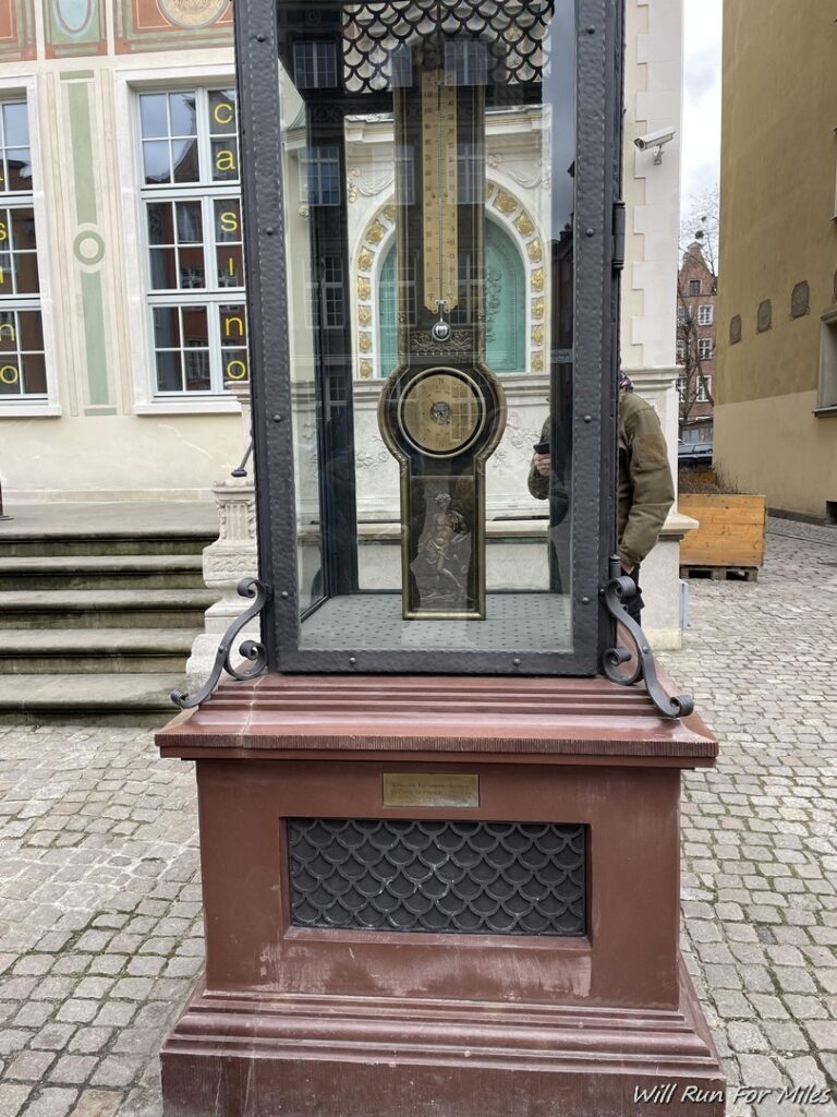 a large glass case with a clock inside