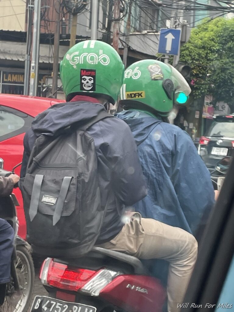 two people riding a scooter