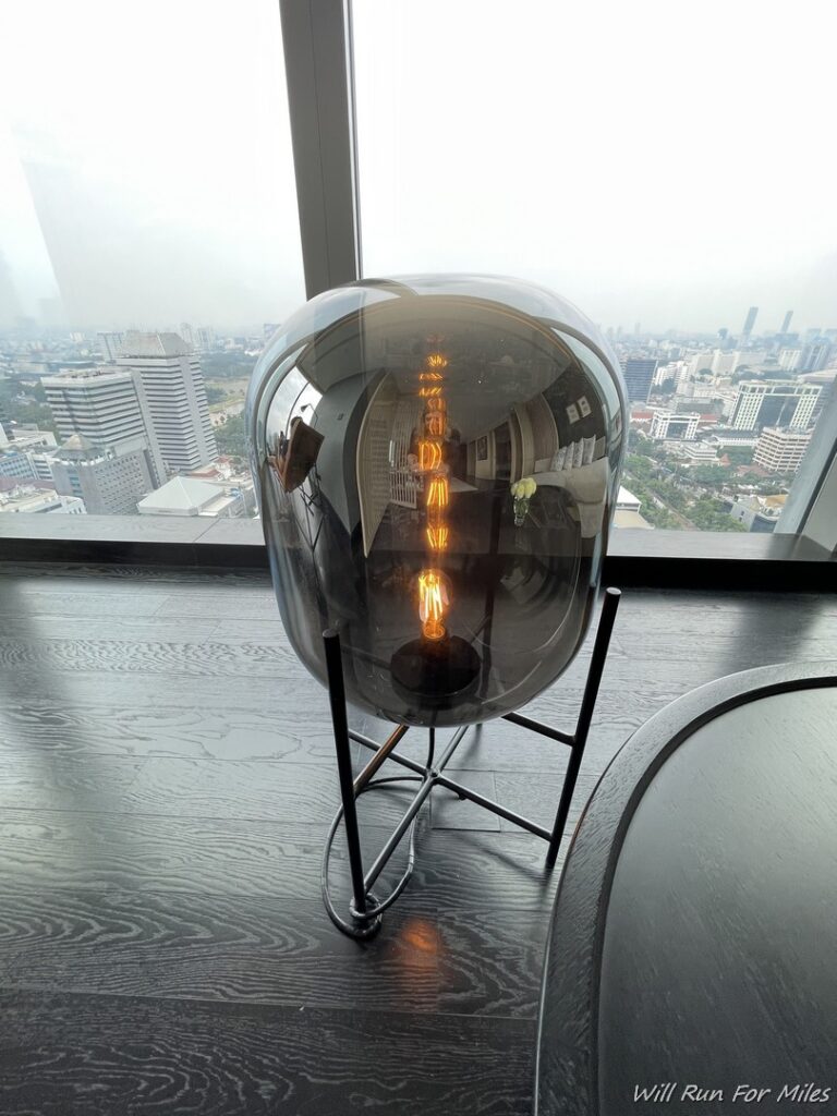 a glass lamp with a light bulb inside
