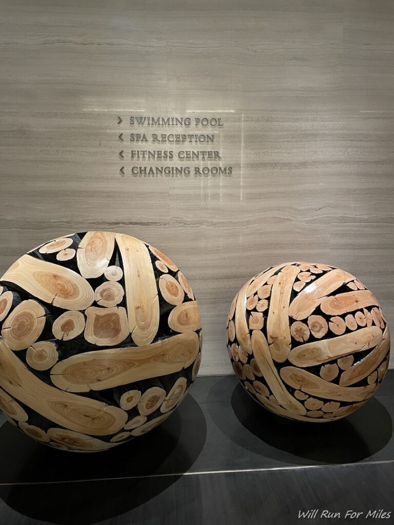 two balls with wood cutouts on a table