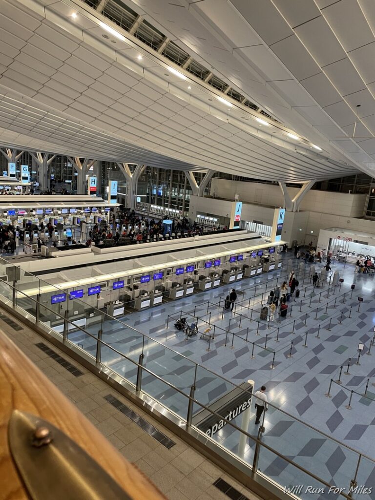 a large airport terminal with people walking around