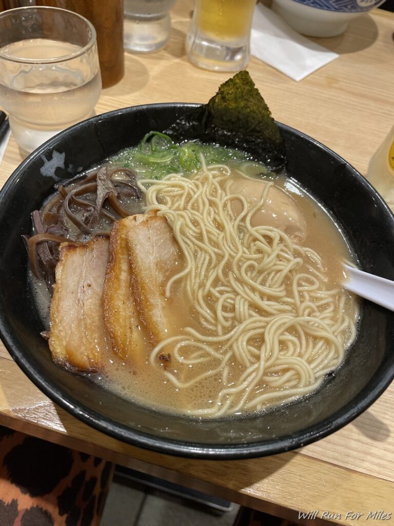 a bowl of ramen soup with meat and noodles